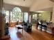 Living room featuring a fireplace, hardwood floors, and a wall of windows at 140 Puckett Creek Dr, Canton, GA 30114