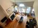 Bright living room with a fireplace, ceiling fan, and hardwood floors at 140 Puckett Creek Dr, Canton, GA 30114