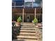 View of a covered patio with retaining walls, steps, and outdoor seating, perfect for relaxation and entertaining at 140 Puckett Creek Dr, Canton, GA 30114