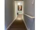 Modern staircase with wooden steps and a white handrail leading to the upper level at 140 Puckett Creek Dr, Canton, GA 30114