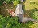 Aerial view of a well-maintained home featuring a spacious backyard, mature trees, and a long, paved driveway at 1759 Kimberly Sw Dr, Marietta, GA 30008