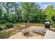 Backyard patio features a grill, seating, lounge chairs, and plenty of room for entertaining at 1759 Kimberly Sw Dr, Marietta, GA 30008