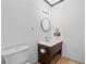 Bathroom with updated vanity, mirror, toilet, and tile floors at 1759 Kimberly Sw Dr, Marietta, GA 30008