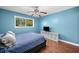 Blue bedroom with bed, wood floors, tv and great natural light from a window at 1759 Kimberly Sw Dr, Marietta, GA 30008