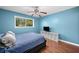 Bedroom with blue walls, hardwood floors, TV, and queen-size bed at 1759 Kimberly Sw Dr, Marietta, GA 30008