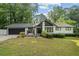 Charming exterior of a one-story home with a well-manicured lawn and mature trees at 1759 Kimberly Sw Dr, Marietta, GA 30008