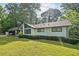 Charming home exterior featuring modern design, well-maintained landscaping, and a lush green lawn at 1759 Kimberly Sw Dr, Marietta, GA 30008
