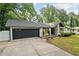 View of one-story home featuring a well-maintained lawn, inviting entryway, and attached garage at 1759 Kimberly Sw Dr, Marietta, GA 30008