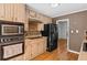 Well-lit kitchen featuring updated appliances, light-colored cabinetry, and a mosaic backsplash for a modern touch at 1759 Kimberly Sw Dr, Marietta, GA 30008