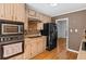 Charming kitchen featuring wooden cabinets, stainless steel appliances, and hardwood floors at 1759 Kimberly Sw Dr, Marietta, GA 30008