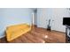 Living room featuring hardwood floors, yellow couch and electric guitar at 1759 Kimberly Sw Dr, Marietta, GA 30008