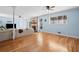 Open-concept living room with hardwood floors, stone fireplace, and modern furnishings, creating an inviting atmosphere at 1759 Kimberly Sw Dr, Marietta, GA 30008