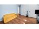 Comfortable living room featuring a yellow sofa, wood floors, and good lighting at 1759 Kimberly Sw Dr, Marietta, GA 30008