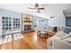 Bright living room with hardwood floors, a stone fireplace, and sliding glass doors to the outdoor patio at 1759 Kimberly Sw Dr, Marietta, GA 30008
