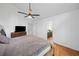 Bedroom featuring hardwood floors, ceiling fan and walk-in to ensuite bath at 1759 Kimberly Sw Dr, Marietta, GA 30008