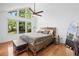 Bright main bedroom featuring vaulted ceilings, large windows and a ceiling fan at 1759 Kimberly Sw Dr, Marietta, GA 30008