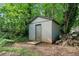 Outdoor storage shed surrounded by nature, perfect for gardening tools or extra storage space at 1759 Kimberly Sw Dr, Marietta, GA 30008