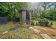 Backyard shed set amongst mature trees provides additional outdoor storage at 1759 Kimberly Sw Dr, Marietta, GA 30008
