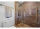 Shower with brown tile and glass door and accessible features at 1759 Kimberly Sw Dr, Marietta, GA 30008