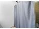 Small shower with neutral tile and a shower curtain at 1759 Kimberly Sw Dr, Marietta, GA 30008
