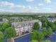 Aerial of a large multi-unit apartment building in a community surrounded by trees at 1975 Nocturne Dr # 2303, Alpharetta, GA 30009