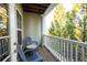 Private balcony with seating area overlooking trees at 1975 Nocturne Dr # 2303, Alpharetta, GA 30009
