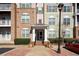 Apartment building exterior featuring a brick and siding facade with a covered entrance and well-maintained landscaping at 1975 Nocturne Dr # 2303, Alpharetta, GA 30009