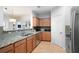 Spacious kitchen with granite countertops, stainless steel appliances, wood cabinets, and tiled backsplash at 1975 Nocturne Dr # 2303, Alpharetta, GA 30009