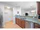 Modern kitchen featuring stainless steel appliances, granite countertops, wood cabinets, and tile backsplash at 1975 Nocturne Dr # 2303, Alpharetta, GA 30009
