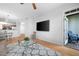 Bright living room with hardwood floors, modern furniture, and a walkout to a private balcony at 1975 Nocturne Dr # 2303, Alpharetta, GA 30009