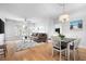 Open-concept living space with hardwood floors, a ceiling fan, comfortable seating, and natural light at 1975 Nocturne Dr # 2303, Alpharetta, GA 30009