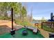 Backyard with outdoor seating, fire pit, faux grass, and shade at 7933 Heathmore Dr, Fairburn, GA 30213