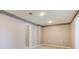 Neutral finished basement area with recessed lighting and architectural features at 7933 Heathmore Dr, Fairburn, GA 30213