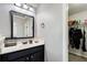 Bathroom with modern vanity, decorative mirror and a closet for storage at 7933 Heathmore Dr, Fairburn, GA 30213