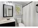 Clean and modern bathroom with a shower, toilet, vanity with mirror, and natural light at 7933 Heathmore Dr, Fairburn, GA 30213