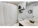 Bathroom with shower and tub combination, featuring modern fixtures and shelving at 7933 Heathmore Dr, Fairburn, GA 30213