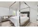 Modern bedroom with a canopy bed and a comfortable couch in the background at 7933 Heathmore Dr, Fairburn, GA 30213