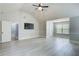 Bright bedroom with a large window, featuring light gray walls and light wood-look floors at 7933 Heathmore Dr, Fairburn, GA 30213