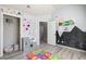 Bright bedroom with playful decor, chalkboard accent wall, and ample closet space at 7933 Heathmore Dr, Fairburn, GA 30213
