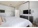 Stylish bedroom with a four-poster bed, dresser, and television at 7933 Heathmore Dr, Fairburn, GA 30213
