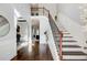 Elegant foyer with hardwood floors, staircase with wrought iron railings, and abundant natural light at 7933 Heathmore Dr, Fairburn, GA 30213