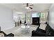 Open-concept living room with fireplace, modern decor, and stylish furniture at 7933 Heathmore Dr, Fairburn, GA 30213