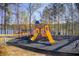 Neighborhood playground featuring colorful play structures, swings, and lake views at 7933 Heathmore Dr, Fairburn, GA 30213