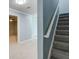 Carpeted staircase with white railing leading to the upper level of the home at 7933 Heathmore Dr, Fairburn, GA 30213
