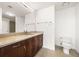 Bathroom featuring a vanity with stone countertops and wood cabinets plus a large mirror at 860 Peachtree Ne St # 2209, Atlanta, GA 30308