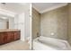 Bathroom featuring a vanity with stone countertops, wood cabinets, and a tile shower and tub combo at 860 Peachtree Ne St # 2209, Atlanta, GA 30308