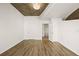 Bedroom featuring wood floors, neutral paint, concrete ceiling, and an ensuite bath at 860 Peachtree Ne St # 2209, Atlanta, GA 30308