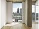 Light-filled living space with large windows offering views of the city skyline and a balcony at 860 Peachtree Ne St # 2209, Atlanta, GA 30308