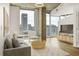 Bright living room featuring hardwood floors, large windows, and a comfortable seating area, perfect for relaxing and entertaining at 860 Peachtree Ne St # 2209, Atlanta, GA 30308