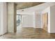 Bright living room features wood floors, concrete pillar, and balcony access for city views at 860 Peachtree Ne St # 2209, Atlanta, GA 30308